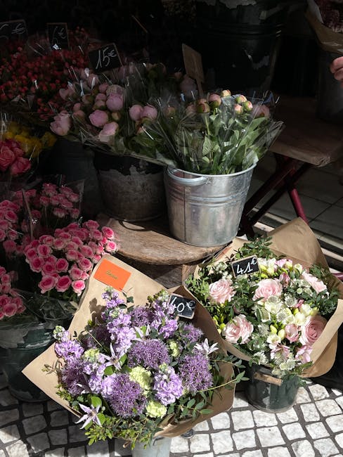 A display of fresh floral arrangements at Yiewsley Florist, featuring mixed bouquets with pink, purple, and white flowers including roses, carnations, and chrysanthemums. The flowers are wrapped in br