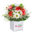 Bright, joyful, and meticulously arranged, this bouquet arrives in a flawless white gift bag-its exuberant colours and textures echoing the lively streets and friendly faces of Yiewsley. Coral and crimson carnations with gently ruffled petals intermingle with radiant white daisies, their golden-green eyes beaming a friendly cheer. Scattered throughout, baby's breath offers fluttering notes of lightness, as soft and uplifting as a fresh morning beside the canal. Slender hints of unopened, purple-tinged buds add an air of anticipation, suggesting the excitement of new celebrations or connections. Enveloped by glossy, vivid green foliage and broad leaves, the blooms are cradled in a lush embrace that enhances their rounded, abundant shape. Presented in a contemporary white gift bag with durable ribbon handles, set against an immaculate background, the arrangement shimmers with energy and tender intention. Ready for delivery anywhere in Yiewsley, this bouquet is perfect for commemorating birthdays, delighting loved ones, or simply brightening homes, all while reflecting the warmth and vibrant spirit that define the community. Every aspect-from colour selection to finishing touch-demonstrates an expert florist's attention to detail and pride in serving the UB7 area.